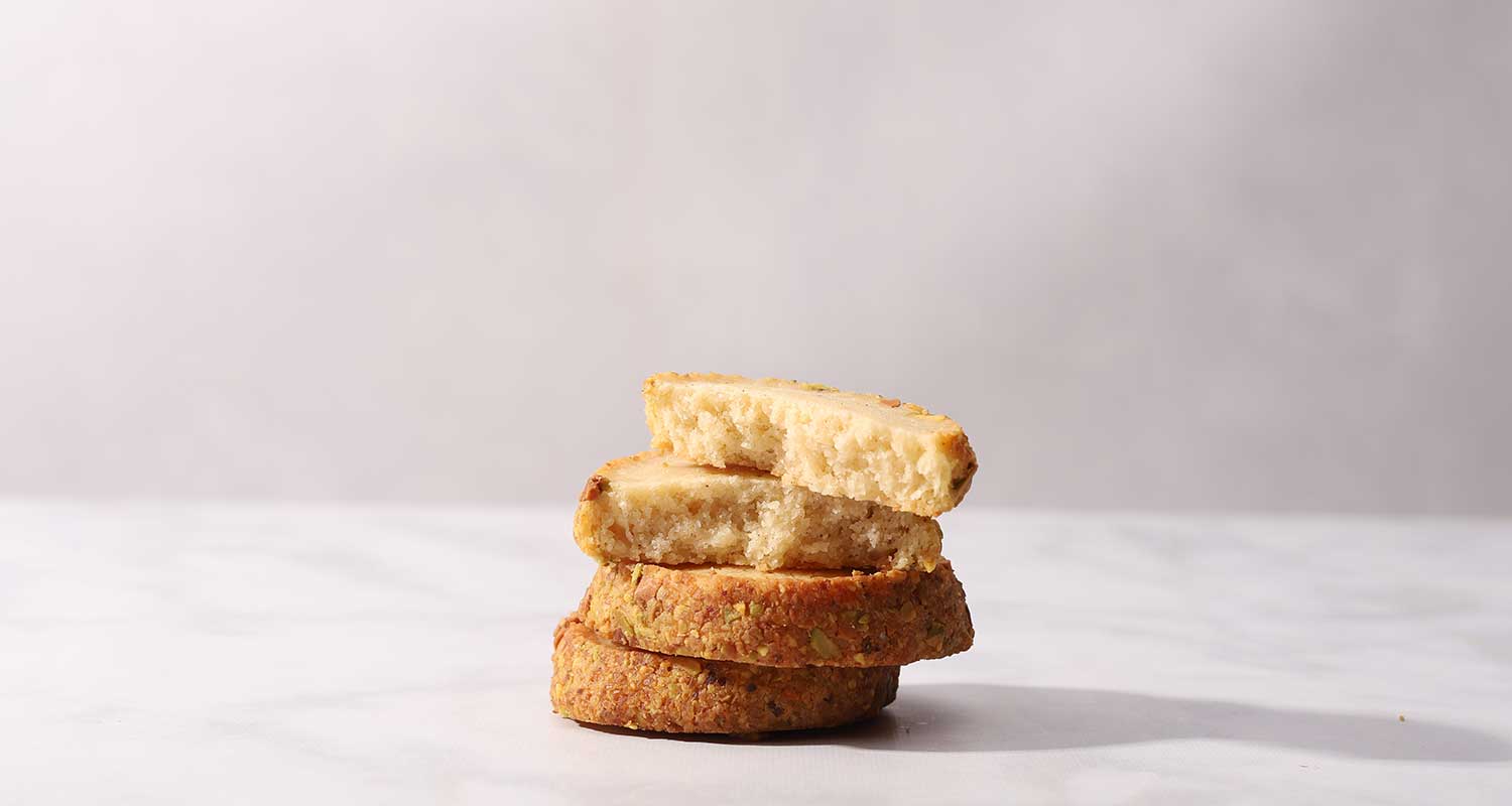 small stack and inside view of pistachio shortbread cookies