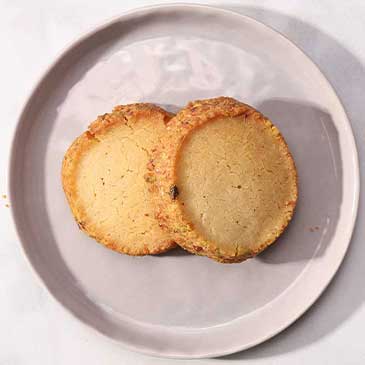 top view of two pistachio shortbread cookies made by standard baking co
