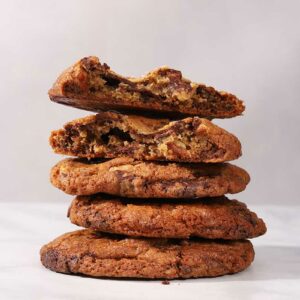 stacked sea salt chocolate pecan cookies with half